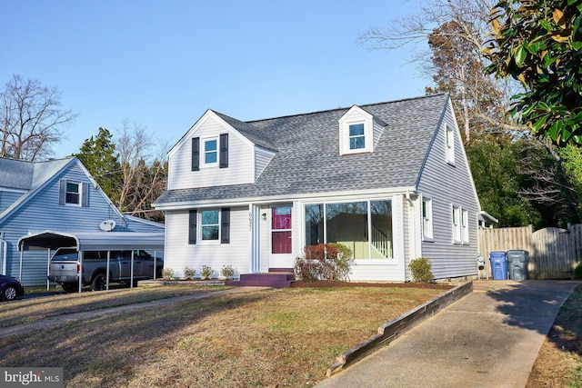 cape cod house with a front lawn, entry steps, fence, roof with shingles, and a detached carport