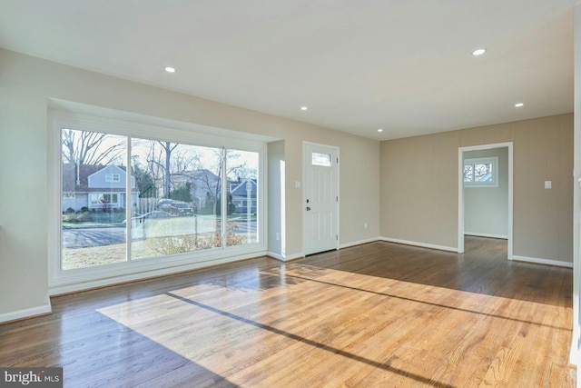 entrance foyer with plenty of natural light, wood finished floors, recessed lighting, and baseboards