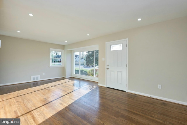 unfurnished room featuring recessed lighting, visible vents, a healthy amount of sunlight, and wood finished floors