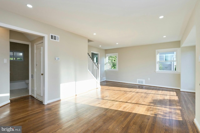 empty room featuring visible vents and wood finished floors