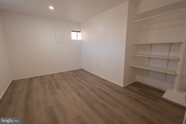 unfurnished room featuring recessed lighting, dark wood-type flooring, and baseboards