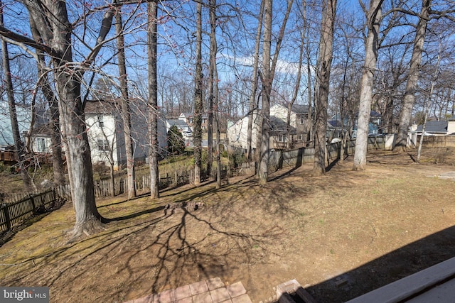 view of yard with a residential view and fence