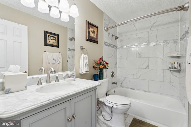 bathroom with vanity, a textured ceiling, shower / bathing tub combination, toilet, and marble finish floor