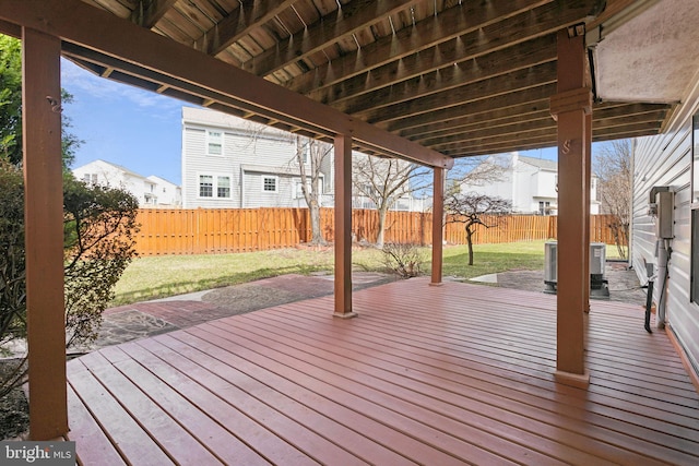 wooden deck featuring a patio area, a yard, central AC unit, and a fenced backyard