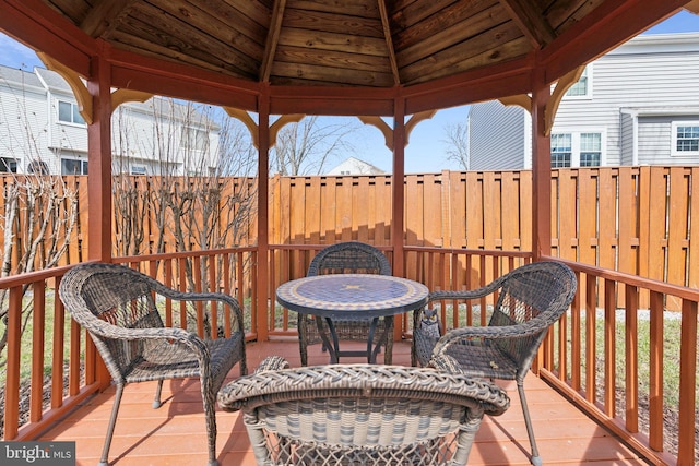 wooden deck featuring a gazebo and a fenced backyard