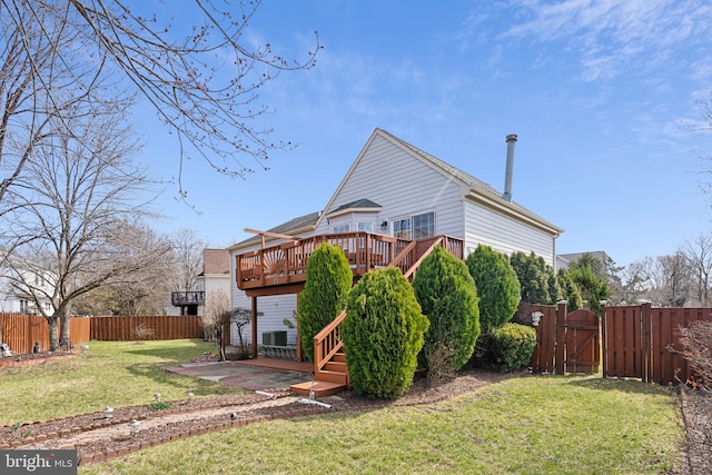 rear view of property with a gate, a fenced backyard, a yard, a wooden deck, and a patio area