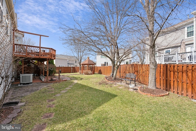 view of yard with a gazebo, central air condition unit, a fenced backyard, and a deck