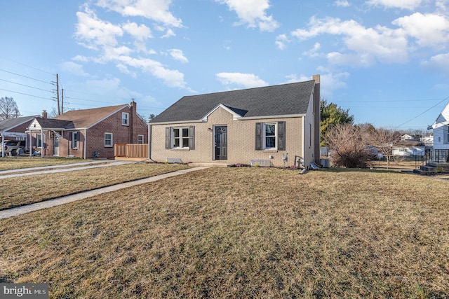 bungalow-style house with brick siding and a front yard