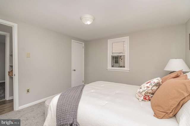 bedroom with baseboards and carpet flooring