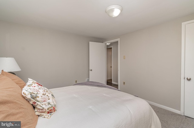 bedroom featuring baseboards and carpet flooring