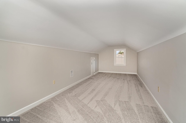 bonus room featuring visible vents, baseboards, and lofted ceiling