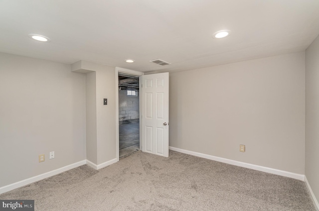 carpeted empty room featuring visible vents, recessed lighting, and baseboards