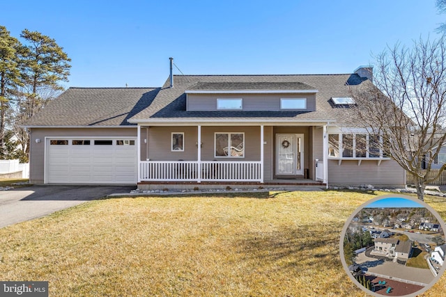 view of front facade with an attached garage, a front lawn, roof with shingles, covered porch, and driveway