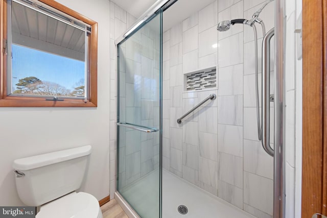 full bath with a shower stall and toilet