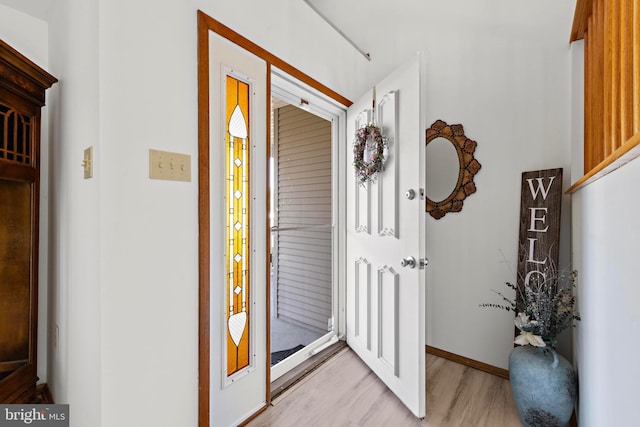 entrance foyer featuring light wood-type flooring and baseboards