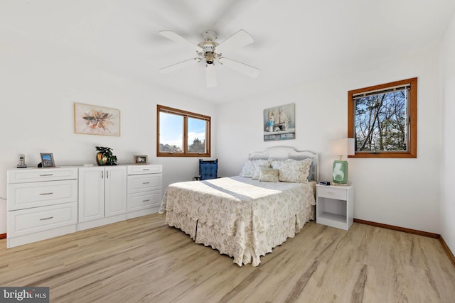 bedroom with light wood-style floors, baseboards, and ceiling fan