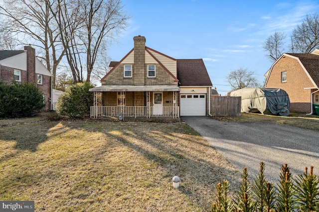 view of front facade featuring roof with shingles, covered porch, a chimney, a garage, and driveway