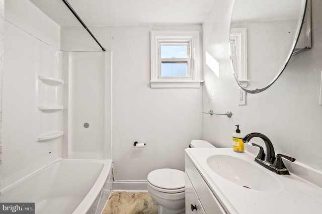 bathroom with baseboards, toilet,  shower combination, and vanity