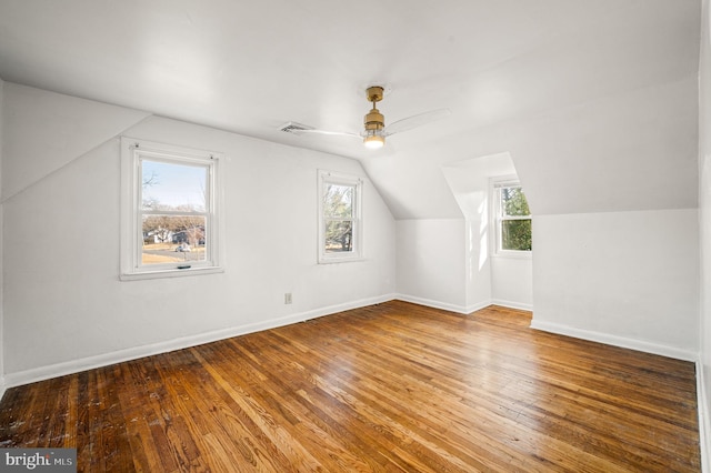 bonus room featuring visible vents, ceiling fan, baseboards, vaulted ceiling, and hardwood / wood-style floors