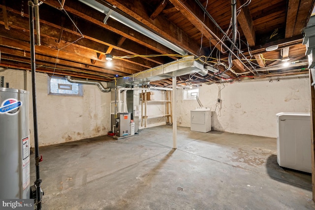 basement with gas water heater, heating unit, and washer and clothes dryer