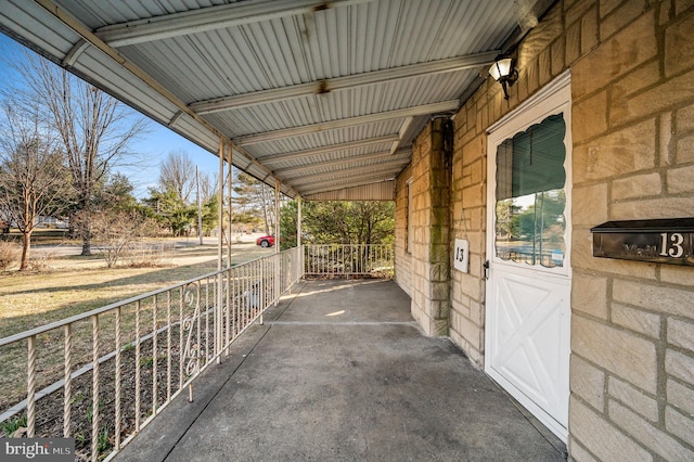 view of patio featuring a porch and a carport