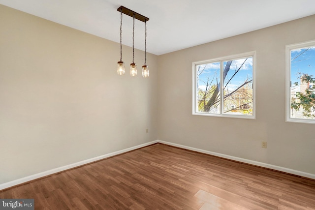 spare room with wood finished floors and baseboards