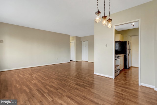 unfurnished living room with dark wood-style floors and baseboards