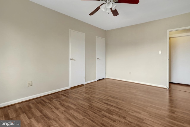 unfurnished bedroom with ceiling fan, baseboards, and wood finished floors