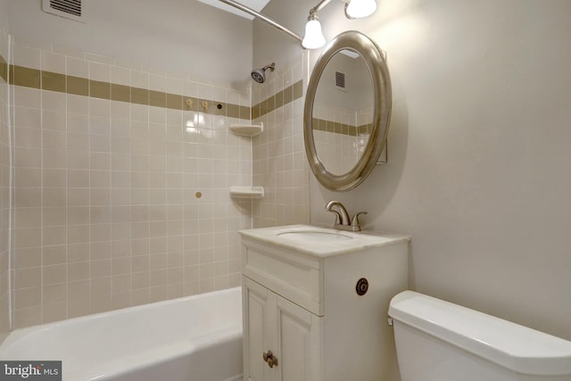 full bath featuring visible vents, vanity, toilet, and shower / bathtub combination