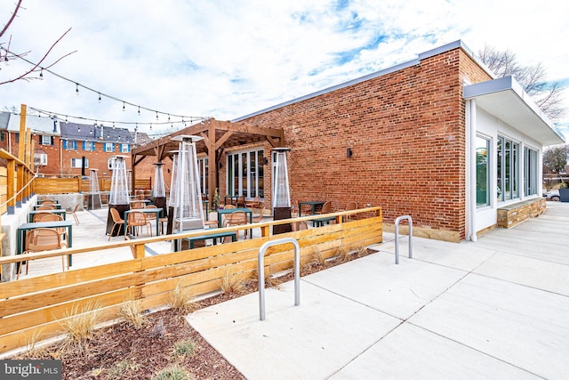 view of patio with a pergola and fence