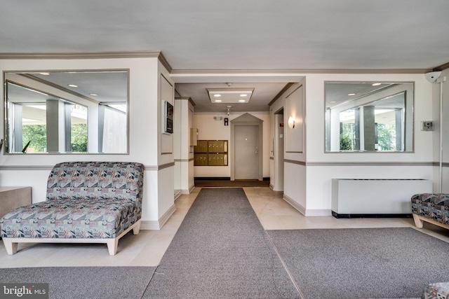 interior space with light tile patterned floors, baseboards, and ornamental molding