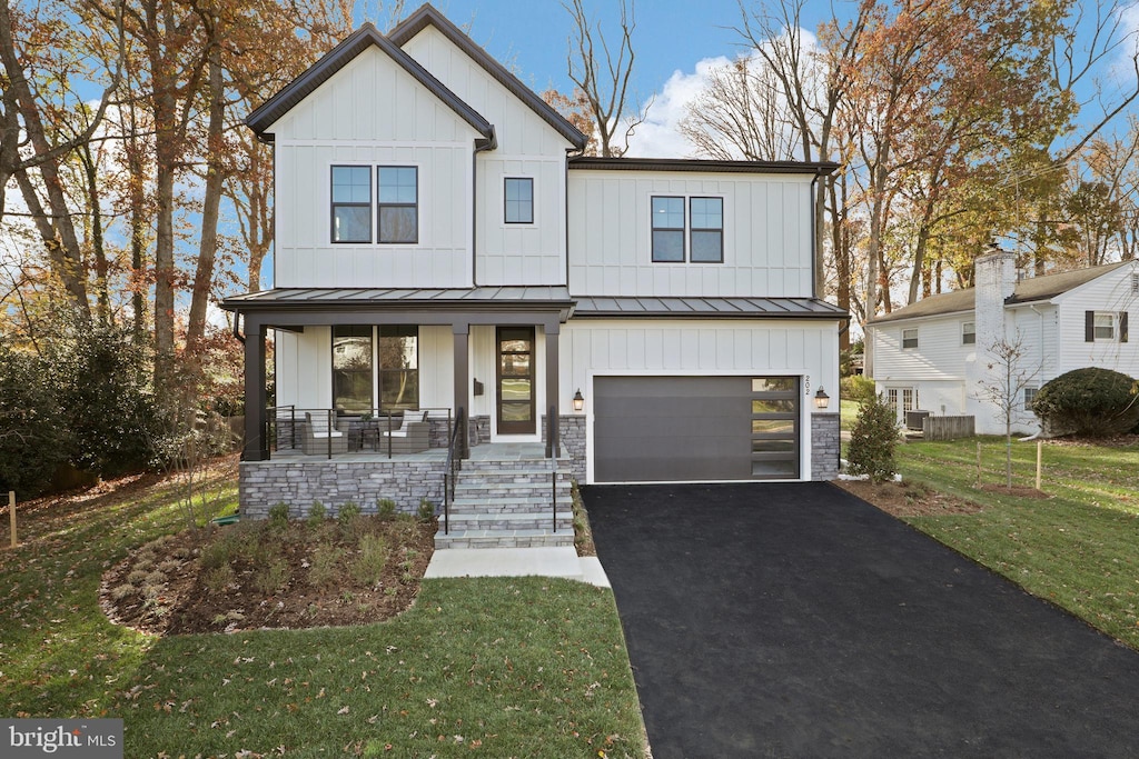 2014 Edgar Ct, Falls Church, VA 22043 - modern inspired farmhouse featuring board and batten siding, covered porch, driveway, and a standing seam roof