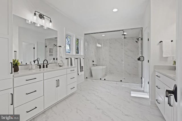 bathroom with vanity, a marble finish shower, a freestanding tub, recessed lighting, and marble finish floor