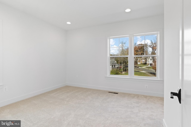 carpeted empty room with recessed lighting, baseboards, and visible vents