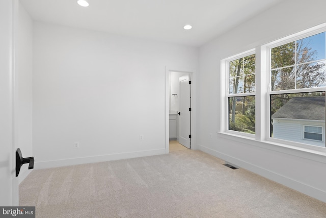 carpeted spare room with visible vents, recessed lighting, and baseboards