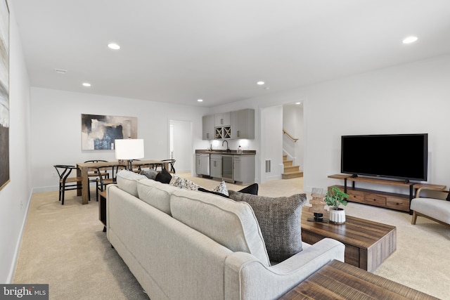 living room with stairway, recessed lighting, wine cooler, and light carpet