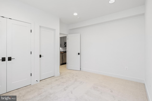 unfurnished bedroom featuring carpet flooring, recessed lighting, and baseboards