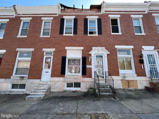 townhome / multi-family property featuring brick siding