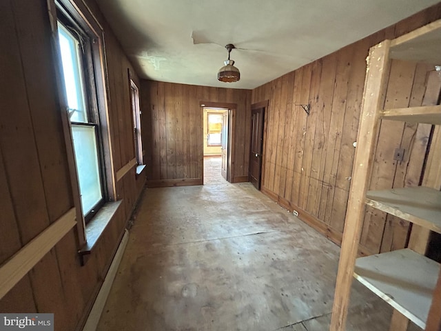 interior space with concrete flooring and wood walls