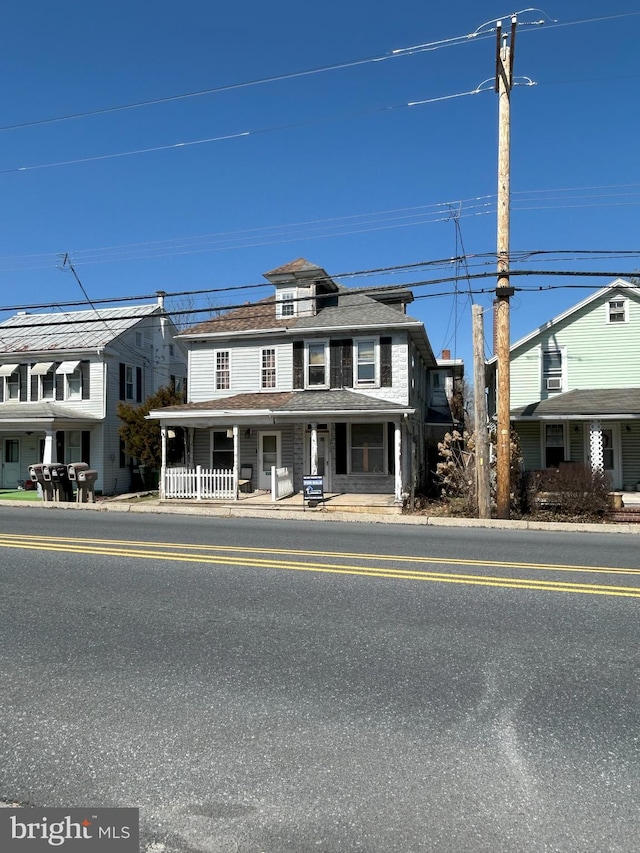 american foursquare style home with covered porch