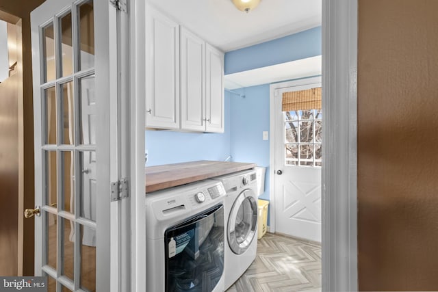 laundry area featuring cabinet space and washer and clothes dryer