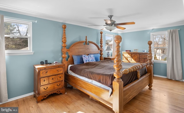 bedroom with crown molding, baseboards, light wood-type flooring, and ceiling fan