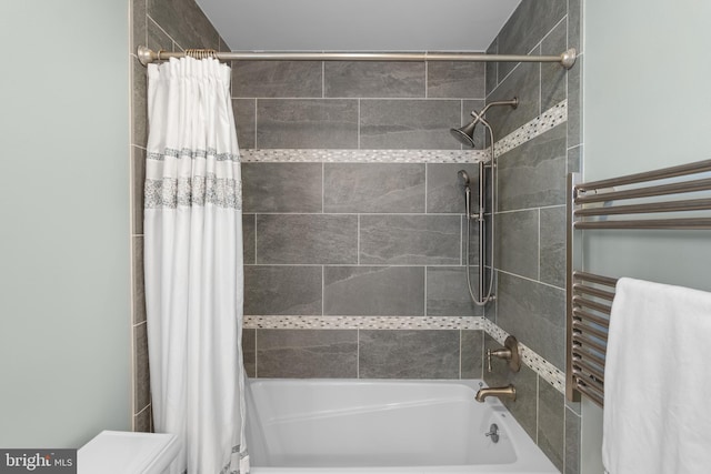 bathroom featuring toilet and shower / bath combination with curtain