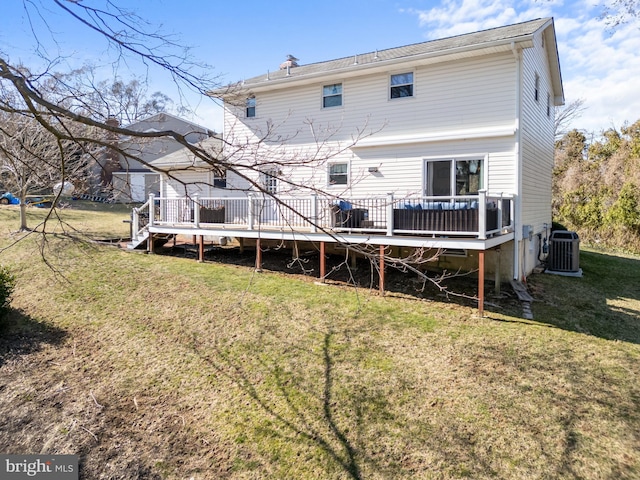 rear view of house featuring a deck, cooling unit, and a yard