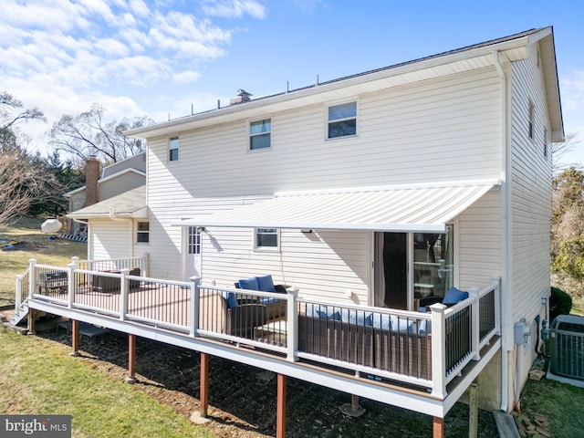 back of house with a deck and cooling unit