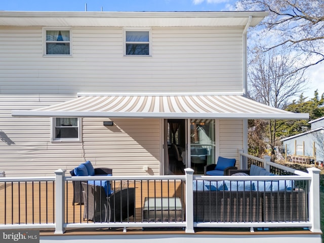 back of property featuring an outdoor living space