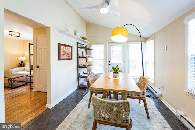 dining room featuring baseboards, baseboard heating, ceiling fan, and vaulted ceiling