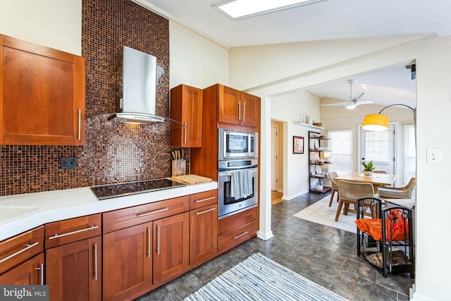 kitchen with lofted ceiling, stone finish flooring, wall chimney exhaust hood, decorative backsplash, and black electric stovetop