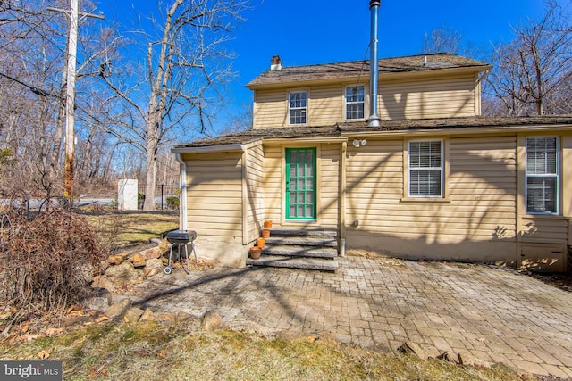 back of property featuring a patio and entry steps