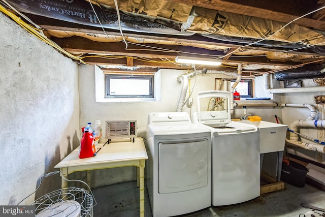 washroom with washer and dryer, laundry area, and a sink